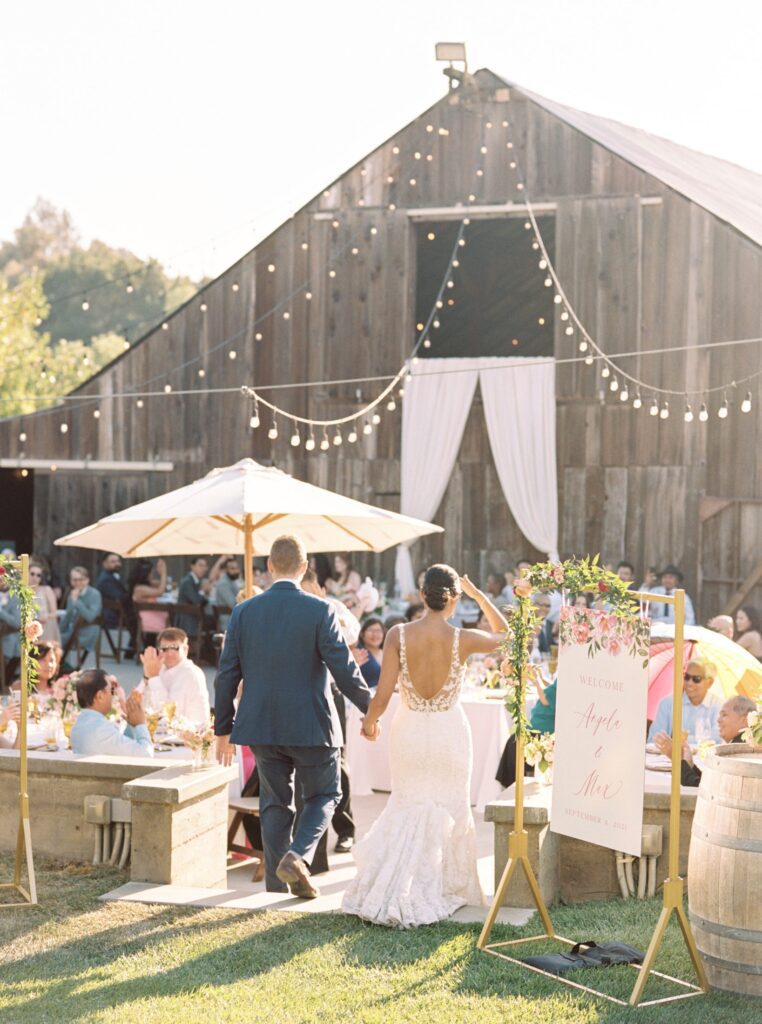 bride and groom enter reception area at luxurious jewish wedding at San Luis Obispo Wedding Venue Higuera Ranch photographed by Fine Art Film Photographer Tina Loveridge of Loveridge Photography