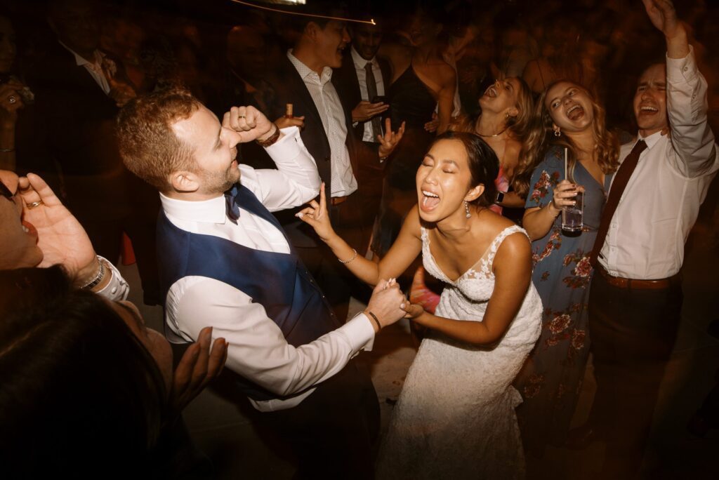 Bride and groom singing and dancing at luxurious jewish wedding at San Luis Obispo Wedding Venue Higuera Ranch photographed by Fine Art Film Photographer Tina Loveridge of Loveridge Photography