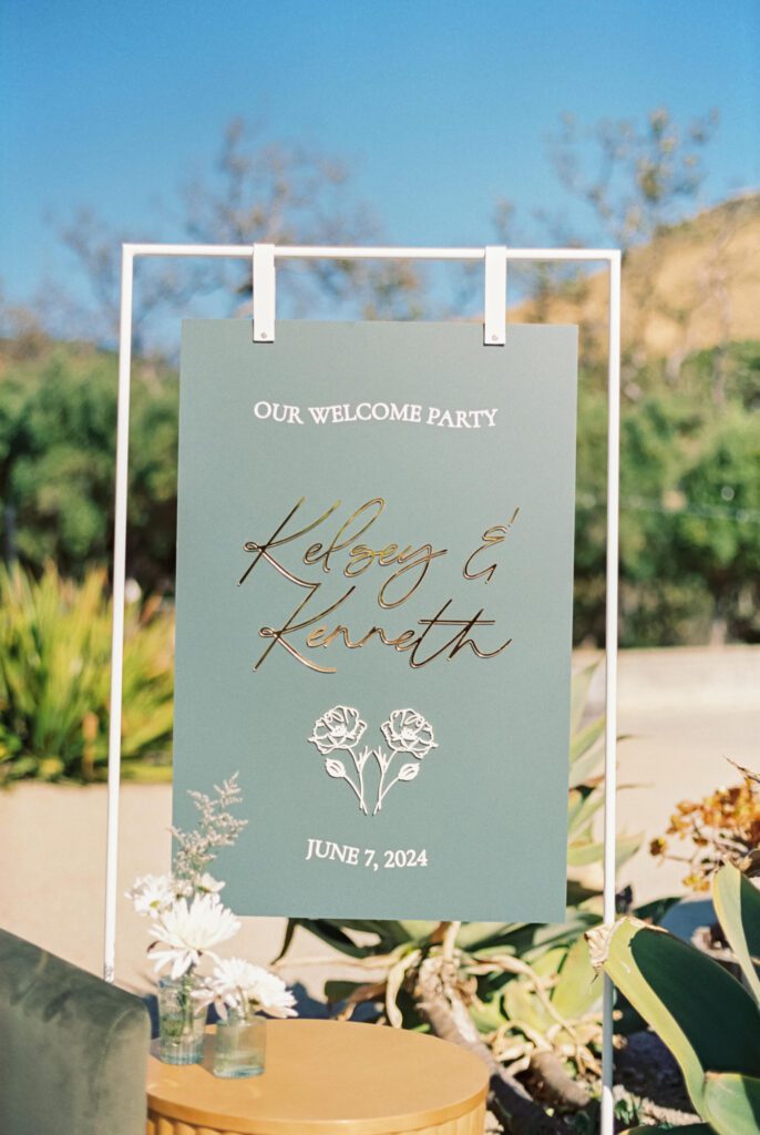 sage color wedding welcome sign present at wedding weekend in the san lucia mountain range at luxury san luis obispo wedding venue Higuera Ranch photographed by Jessica Sofranko Photography