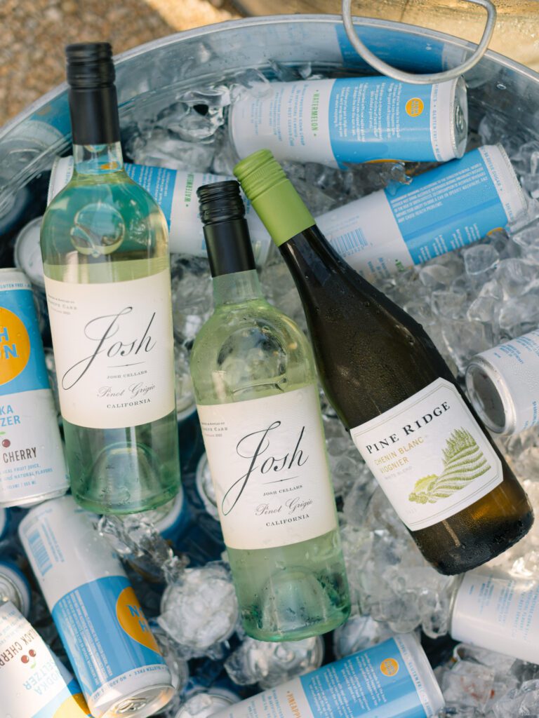 Josh wines in ice for rehearsal dinner at wedding weekend in the san lucia mountain range at luxury san luis obispo wedding venue Higuera Ranch photographed by Film Photographer Jessica Sofranko